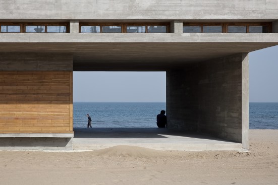 Passageway from west, with wood cladding of facade (at left) folding 90 degrees into bench