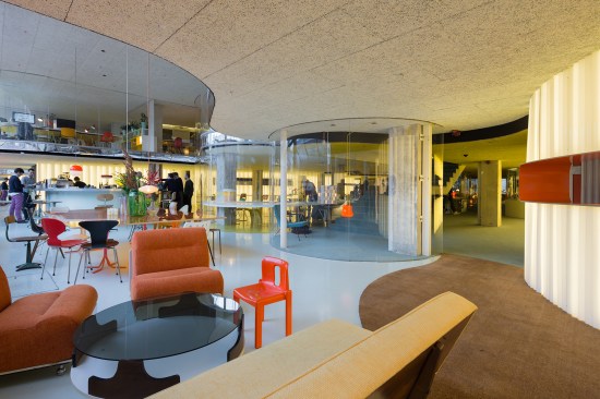 Office interior showing breakout spaces and meeting room pods.