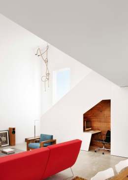 A smart little nook under the stairs utilizes an otherwise wasted space.