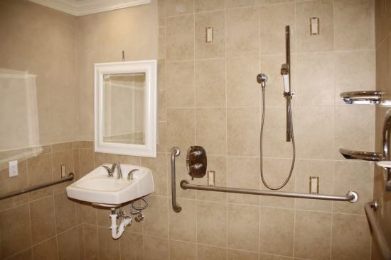 The master bathroom has an easily accessible roll-in shower featuring Toto low-flow faucets and showerheads.

