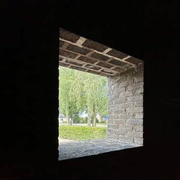 From the inside of Sankt Petri Kyrka, or Saint Peter's church by Sigurd Lewerentz in Klippan, Sweden. According to Eric Höweler, the window appears open and monolithic, with no frame or mullions.