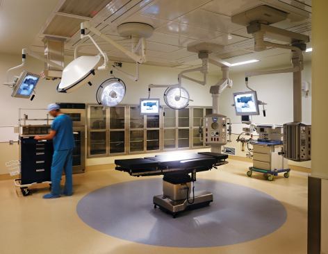 The first floor of the building plays host to several general surgery operating rooms. In order to maintain a sterile environment, resilient flooring and wipeable metal fixtures outfit the spaces. Resilient flooring: Nora; Noraplan Mega in Arctic Ice and Toffee; norarubber.com - Paint: Sherwin-Williams; Interior paint; sherwin-williams.com