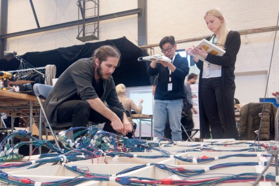 Kenton Phillips from the Center for Architectural Science & Ecology at Rensselaer Polytechnic Institute connects lights and sensors to a central control unit of the Atmospheric Delight project.
