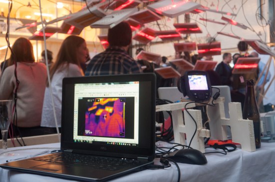 A thermal camera monitors the temperature of individuals sitting under the heating and lighting panels created by the Atmospheric Delight cluster.