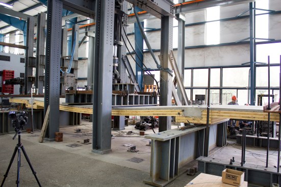 Load test of full-scale mass-timber composite floor system, with applied load at eight times that of the design service load.