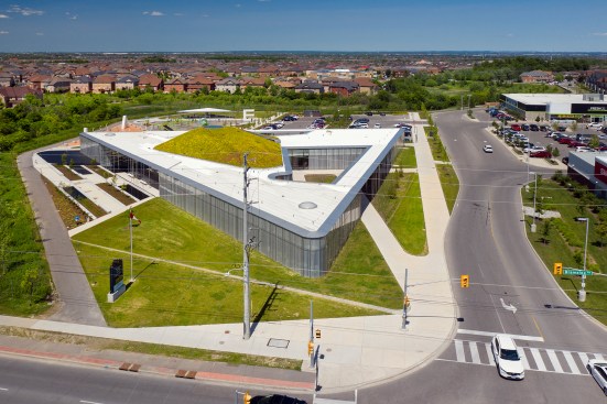 An aerial view from the south shows how the library’s triangular plan maximizes green space on the suburban site. 