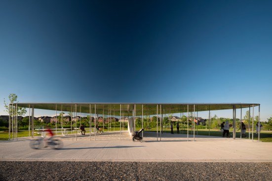 A thin, stainless-steel canopy creates a covered play area at the northern edge of the site, and picnic tables provide seating for parents and caregivers. 