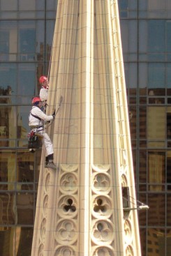 Workers survey the condition of a cathedral tower.