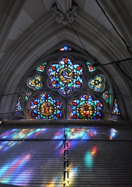 Restored stained glass rosettes and trefoils