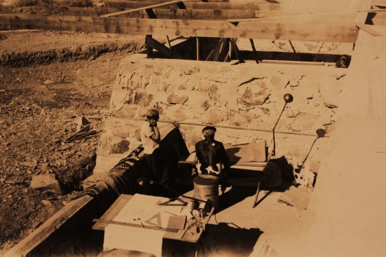 Frank Lloyd Wright working at a drafting table during the original construction of Taliesin West (circa 1938)