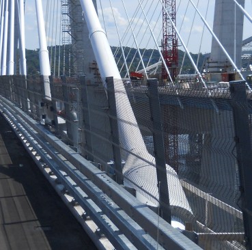 Closer look at a stay cable tensioned to outside section of structural steel.