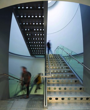 The black lozenge on the south side of the structure encloses a central stair. An oculus in the carbon-fiber envelope brings daylight into the enclosure.