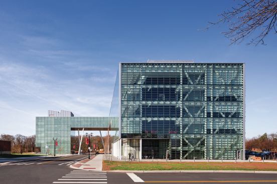 The north end of the L-shaped building is also glazed, placing the internal trusswork and structure on display.