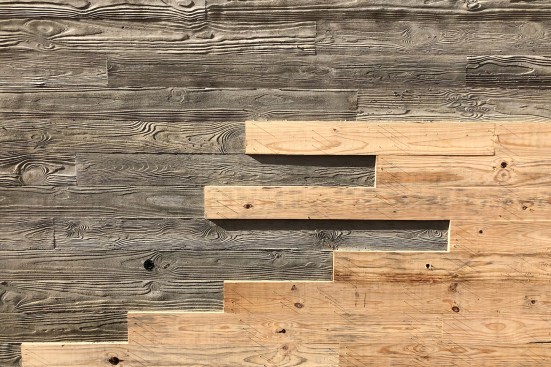 Wood forms being removed from the facade of TheatreSquared's new performing arts complex in Fayetteville, Arkansas, created by Marvel Architects.