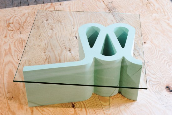 One piece in The Principals’ Dead Chair Table series places a glass top on Frank Gehry, FAIA’s Wiggle Chair to make it function as a different kind of furniture.