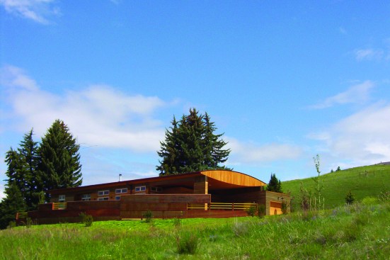 The predominant feature of the Hill House in Bozeman is its long, bow-truss roof, which allows panoramic views of the valley below.