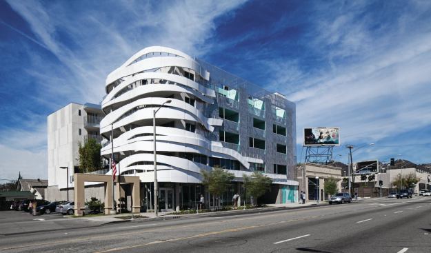 White ribbons of panelized metal wrap the building’s southeast corner. 