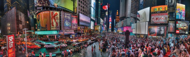 Times Square visitors take in the scene from the red steps of the TKTS booth and Snøhetta’s granite benches