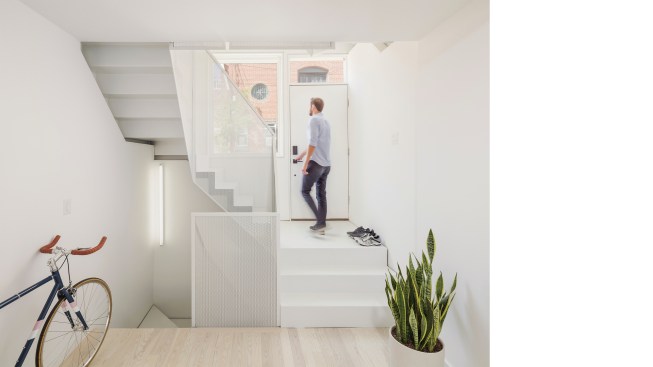 Gypsum board walls and ceilings in the main entry and throughout are coated in Sherwin-Williams paint, and are complemented by light Bellawood floors.