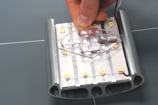 Specially molded lenses focus and direct the light emitted by high-flux LEDs in order to cast ample light on the streets at night. The modular design of the LED array allows the diodes to be switched out easily as technology changes and becomes more efficient.
