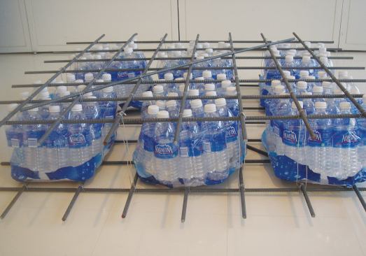 A mock-up of the SFIS with bundled plastic bottles. Most plastic water bottles are discarded with the caps on; capped, empty bottles are airtight and can be placed within a concrete structure to create a void. Hydrostatic pressure from wet concrete will only nominally reduce the air volume inside the bottles.