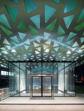 With the new gatehouse, the architects and their client realized a longstanding shared ambition: to use Trumpf's own technology to construct a building entirely of laser-cut and welded sheet metal. Above the gatehouse's functional core, which is enclosed in a glass pavilion, a honeycombed stainless steel roof cantilevers more than 60 feet.
