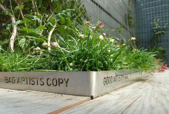 Custom stainless steel planters fabricated by Shift_Design contain laser-cut quotes.
