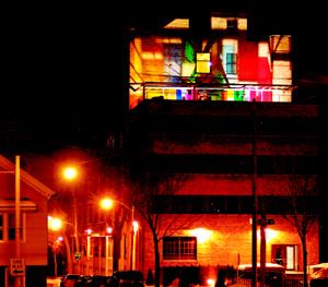 But the real drama is in the image the terrace sends out to the city. When the lights go on, the plastic panels create a colorful glowing beacon for the gritty industrial neighborhood and the freeway beyond.
