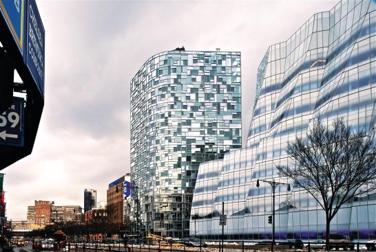 The matrix of frames created by the windows scatters reflections on the outside.