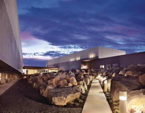 The separation of commercial and noncommercial operations into two buildings allowed Siegel to create a secure central courtyard. Hidden from public view by an enclosed bridge at one end and a berm at the other, the landscape design—on which the architects collaborated with Sasaki Associates—is a literal interpretation of the site's history as a glacial path. Granite boulders found during site excavation were salvaged and arranged here as a nod to the rocky path left behind by a glacier.