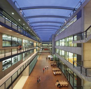 The school’s new building is also organized around a large, covered atriumlike space. Referred to as the Covered Street, it is topped by an ETFE roof. 