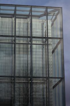 The stainless steel screen is located within the cavity at 22 inches in front of the inner glass layer and is composed of a pattern of triangular-shaped bars.