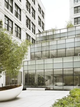 Long-span additions step up from the second-floor courtyard