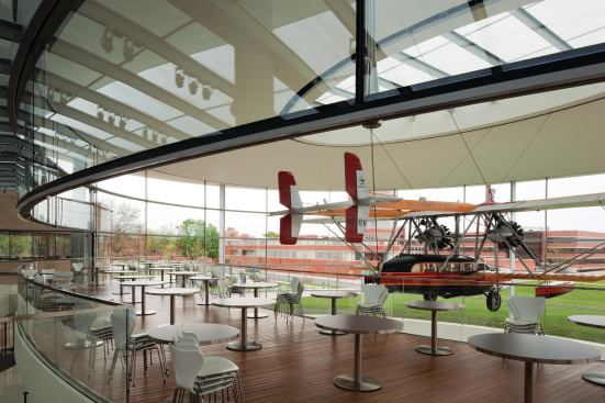 The balcony in Fortaleza Hall is at eye level with the Carnaúba. "You almost feel like you are floating up in the clouds with the plane," Robinson says. Designed as a part of the glass pavilion, the balcony serves as a bridge to The Commons and as one of the new building's four employee eateries. Giving those employees direct access to the plane was very important to company chairman and CEO and Sam's son, Fisk Johnson, as a means to engage them with his family's and the company's history. That history is detailed in a ground-floor gallery, which features artifacts from Sam Johnson's journey.