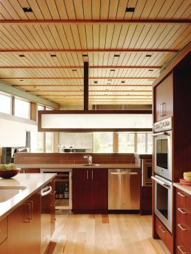 A bar-height backsplash helps conceal cooking operations from the adjacent dining area.

