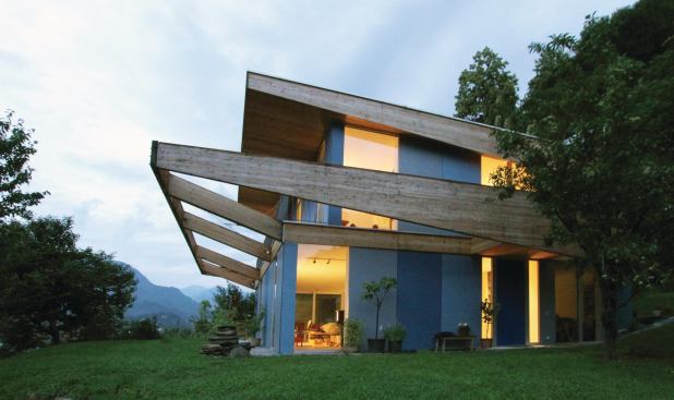 Swiss Precision

 Located in Solduno, Switzerland, Casa Locarno sits at the base of a mountain with a view to Lake Maggiore. Its signature element is the Skyframe, a roof cantilever that will eventually be covered in vegetation to provide even more shade on the expansive windows; it and the slightly sloping green roof above it also afford taller ceiling heights for the public rooms inside while helping integrate the house into its environment. Size: 178 square meters (approximately 1,916 square feet); Architect: designyougo, Berlin, Germany.
