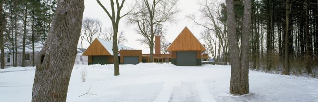 Sited on a bluff overlooking the Mississippi River, the Albrecht Residence is a cubist modern building wedged between two bookends with steeply pitched roofs.