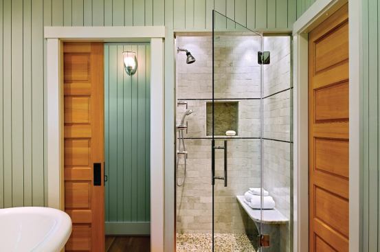 A pocket door next to the shower leads to a windowed water closet.