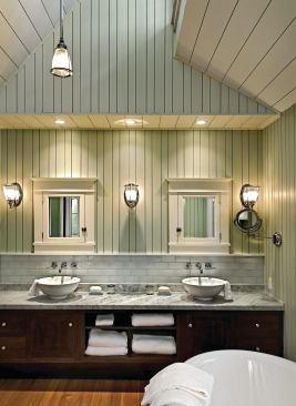 Simple but strong materials—subway tiles, marble countertops, a radiant-heated heart pine floor—impart cottage-style comfort in this Boothbay Harbor bath.