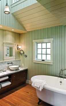 A skylit dormer brightens the room, and reveals in the wall board create an irregular, eye-catching pattern.
