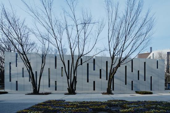 East façade showing cuts through the concrete panels.
