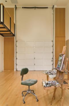 An operable, interior garage door separates the painting studio from the living room.