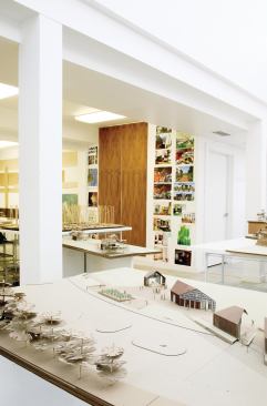 The ground floor features an office, wood shop, and a guest suite for summer interns.