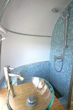 Bamboo coutertops and floors brighten the trailer's interior, as does a recycled-glass tile shower space.