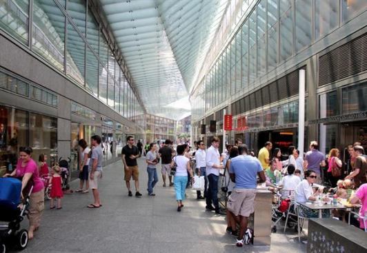 The arcade serves as a passageway, destination, and meeting place.