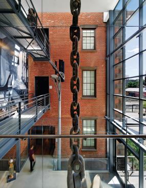Relics from the site’s naval past fill the lobby; tickets for the galleries can be purchased at the front desk, which was fabricated by Ferra Designs, the same firm responsible for the Cor-Ten benches in the forecourt.