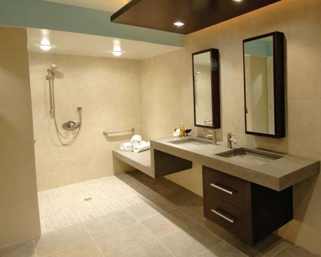 The shower’s parallel “wet” and “dry” benches allow a caretaker to stay dry while helping the client’s son bathe.