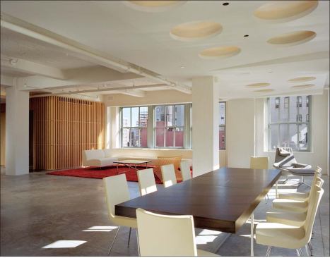 The architects anchored the loft spatially with two wood and glass cores that house the baths and a home office.