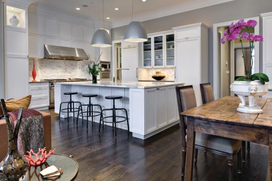 A simple traditional white kitchen adjoins the rear great room