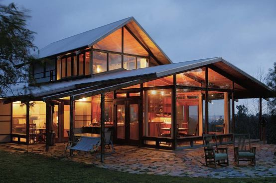 Glass walls on the exterior and a lack of walls inside let the 1,500-square-foot house live large. Outdoor terraces and porches nearly double the home’s total square footage.